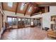 Spacious living room with vaulted ceiling, multiple windows, and scenic mountain views at 34127 Cactus Dr, Evergreen, CO 80439