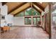 Bright living room with vaulted ceilings, skylights, and views of the lush outdoors at 34127 Cactus Dr, Evergreen, CO 80439