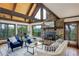 Inviting living area with vaulted ceilings, stone fireplace, and natural light at 34127 Cactus Dr, Evergreen, CO 80439