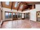 Living room features vaulted ceilings, terracotta floors, skylights, and doors to deck at 34127 Cactus Dr, Evergreen, CO 80439