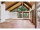 Bright room with terracotta floors, high ceilings, and triangular window overlooking greenery at 34127 Cactus Dr, Evergreen, CO 80439