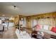 Inviting living room featuring wood walls, neutral furniture, and seamlessly connected with an open-concept kitchen at 34127 Cactus Dr, Evergreen, CO 80439