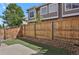 Private backyard with wood fence, artificial grass, and a concrete patio at 1356 Carlyle Park Cir, Highlands Ranch, CO 80129