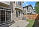 Backyard features a private concrete patio, artificial grass, and access to sliding glass door at 1356 Carlyle Park Cir, Highlands Ranch, CO 80129