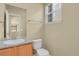 Well-lit half-bath with granite counters and ample natural light at 1356 Carlyle Park Cir, Highlands Ranch, CO 80129