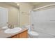 Bright bathroom features a granite vanity, framed mirror, and shower over tub with glass doors at 1356 Carlyle Park Cir, Highlands Ranch, CO 80129
