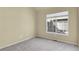 This bedroom has neutral carpet, a double window, and a wall of light-yellow paint at 1356 Carlyle Park Cir, Highlands Ranch, CO 80129