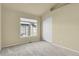 Carpeted bedroom with a large window and closet has a neutral color scheme at 1356 Carlyle Park Cir, Highlands Ranch, CO 80129