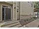 A welcoming front entrance with stone accents and a gray front door at 1356 Carlyle Park Cir, Highlands Ranch, CO 80129