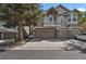 Charming townhome featuring a two-car garage, balcony, and stone accents at 1356 Carlyle Park Cir, Highlands Ranch, CO 80129