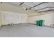 Spacious garage with epoxy floor, shelving, and room for parking and storage at 1356 Carlyle Park Cir, Highlands Ranch, CO 80129