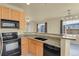 A view of kitchen with granite counters and stainless appliances looking into dining area at 1356 Carlyle Park Cir, Highlands Ranch, CO 80129