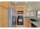 Light-filled kitchen with a view of the dining area and stainless appliances at 1356 Carlyle Park Cir, Highlands Ranch, CO 80129
