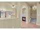 A bright, open-concept living room featuring a fireplace and archways at 1356 Carlyle Park Cir, Highlands Ranch, CO 80129