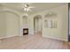 A cozy living room features a fireplace and archways, complemented by neutral walls and floors at 1356 Carlyle Park Cir, Highlands Ranch, CO 80129