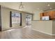 A sun-lit living room featuring light-colored flooring, sliding glass doors, and a breakfast bar at 1356 Carlyle Park Cir, Highlands Ranch, CO 80129