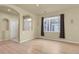 A bright living room featuring an archway, large windows, and neutral walls at 1356 Carlyle Park Cir, Highlands Ranch, CO 80129