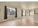 A bright living room with light-colored floors and natural light from several windows at 1356 Carlyle Park Cir, Highlands Ranch, CO 80129