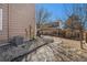 Backyard with a patio seating area and mature trees creating a serene outdoor space at 715 Mockingbird St, Brighton, CO 80601