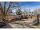 Outdoor patio space with furniture, fenced yard, and mature trees, creating a relaxing atmosphere at 715 Mockingbird St, Brighton, CO 80601