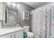 Charming bathroom featuring a vanity with a mirror, toilet, and shower with a fun curtain at 715 Mockingbird St, Brighton, CO 80601