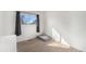 Bright bedroom with wood floors featuring a large window and space for a pet bed at 715 Mockingbird St, Brighton, CO 80601