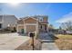 Inviting two-story home with a well-maintained yard, and attached two-car garage under a beautiful clear sky at 715 Mockingbird St, Brighton, CO 80601