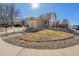 Charming home featuring a well-manicured lawn, stone walkway, and a welcoming front entrance with an attached garage at 715 Mockingbird St, Brighton, CO 80601