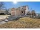 Well-maintained home featuring a manicured lawn, stone walkway, and a welcoming front entrance with an attached garage at 715 Mockingbird St, Brighton, CO 80601