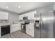 Well-lit kitchen with stainless steel refrigerator, microwave, and sleek appliances at 715 Mockingbird St, Brighton, CO 80601