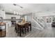 Open-concept kitchen and dining area with stainless steel appliances and stairs to the second floor at 715 Mockingbird St, Brighton, CO 80601