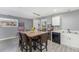 Dining area featuring wood floors and a modern light fixture above the table at 715 Mockingbird St, Brighton, CO 80601