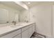 Modern bathroom with a double sink vanity and large mirror at 1288 S Algonquian St, Aurora, CO 80018