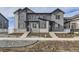 Modern townhouse exterior with gray siding, brick accents, and inviting entryway steps at 1288 S Algonquian St, Aurora, CO 80018