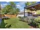 Landscaped backyard with artificial turf, pergola, and ping pong table at 2063 Cherry St, Denver, CO 80207