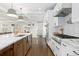 Bright kitchen featuring white cabinets, stainless steel appliances, and a spacious island at 2063 Cherry St, Denver, CO 80207