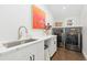 Modern laundry room with quartz countertops and new appliances at 2063 Cherry St, Denver, CO 80207