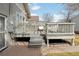 Elevated wooden deck featuring gray wood railings, outdoor seating and a view of the backyard at 764 S Corona St, Denver, CO 80209