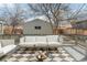 Outdoor back deck featuring a cushioned outdoor sofa, fire pit, and views of the backyard and detached garage at 764 S Corona St, Denver, CO 80209