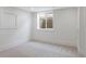 Clean basement bedroom features a large window, new carpet and fresh, bright walls at 764 S Corona St, Denver, CO 80209