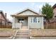 Charming home featuring a brick facade, manicured lawn, and inviting front porch at 764 S Corona St, Denver, CO 80209
