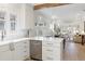 Bright, open kitchen with white cabinets, stainless steel appliances, and pendant lighting at 764 S Corona St, Denver, CO 80209