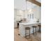 Bright kitchen featuring a center island with bar seating, pendant lighting, and modern cabinetry at 764 S Corona St, Denver, CO 80209