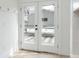 White french doors open to a back patio with a chic black and white checkered rug at 764 S Corona St, Denver, CO 80209