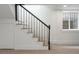 Basement staircase with black metal railing and hardwood treads leads to finished space at 764 S Corona St, Denver, CO 80209