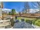 The backyard features a stone patio, a hot tub, a grill, an outdoor dining area and landscaping at 20948 E Hamilton Ave, Aurora, CO 80013