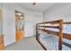 Bedroom featuring a bunk bed, neutral walls and carpet, a closet and hall access at 20948 E Hamilton Ave, Aurora, CO 80013
