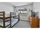 Bedroom featuring a bunk bed, dresser, neutral walls and carpet, and good light at 20948 E Hamilton Ave, Aurora, CO 80013