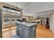 Open concept kitchen with island, granite countertops, and wood flooring, perfect for entertaining and cooking at 20948 E Hamilton Ave, Aurora, CO 80013