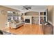 Cozy living room features hardwood flooring, a fireplace, neutral paint, and custom built-ins at 20948 E Hamilton Ave, Aurora, CO 80013